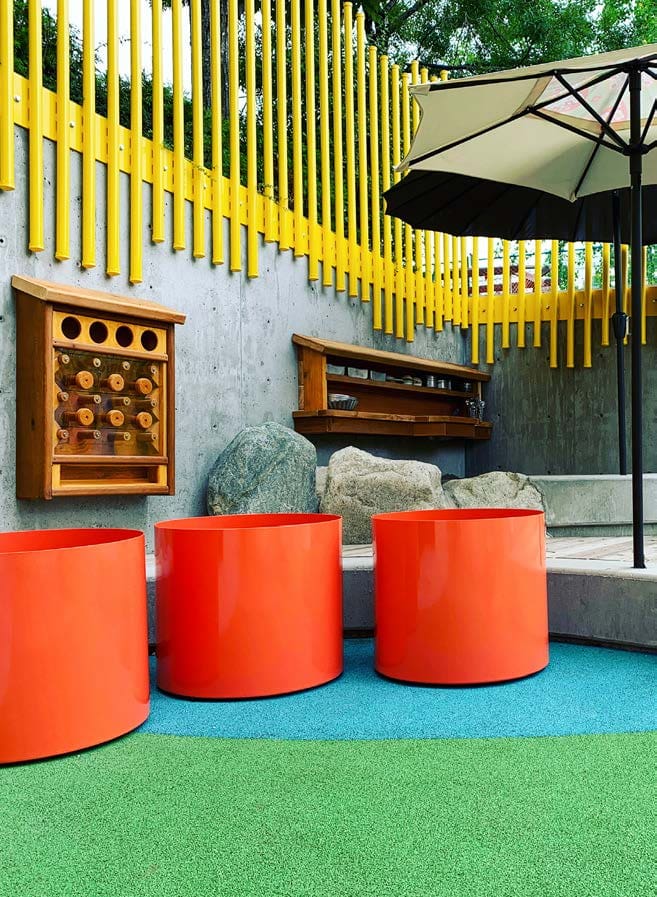 3 orange cylinder planters